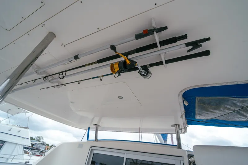 Slide: The Image of Fishing rods stored on a 2011 Leopard 38 catamaran's ceiling rack. - 52