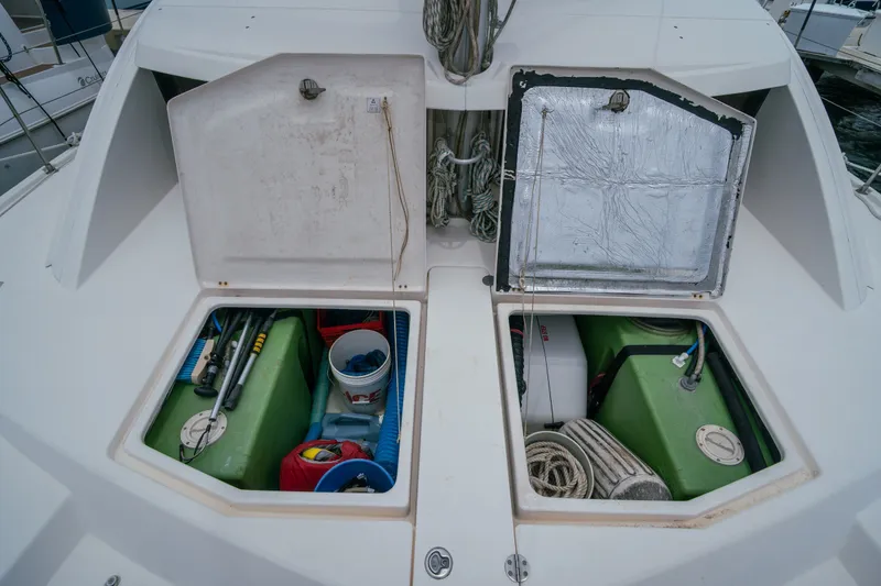 Slide: The Image of Open storage compartments on a 2011 Leopard 38 catamaran, revealing equipment and supplies. - 155