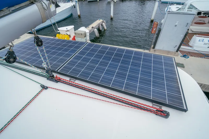Slide: The Image of Solar panels on a 2011 Leopard 38 catamaran docked at a marina. - 44