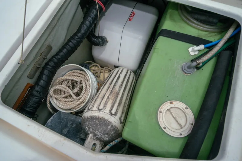 Slide: The Image of Storage compartment of a 2011 Leopard 38 boat with ropes and equipment. - 151