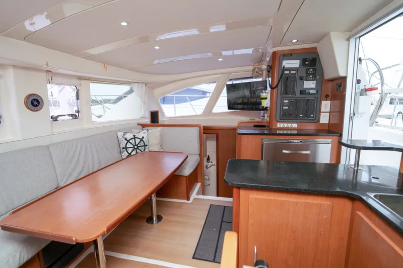 Slide: The Image of Interior of 2011 Leopard 38 catamaran with dining area, navigation panel, and modern amenities. - 102