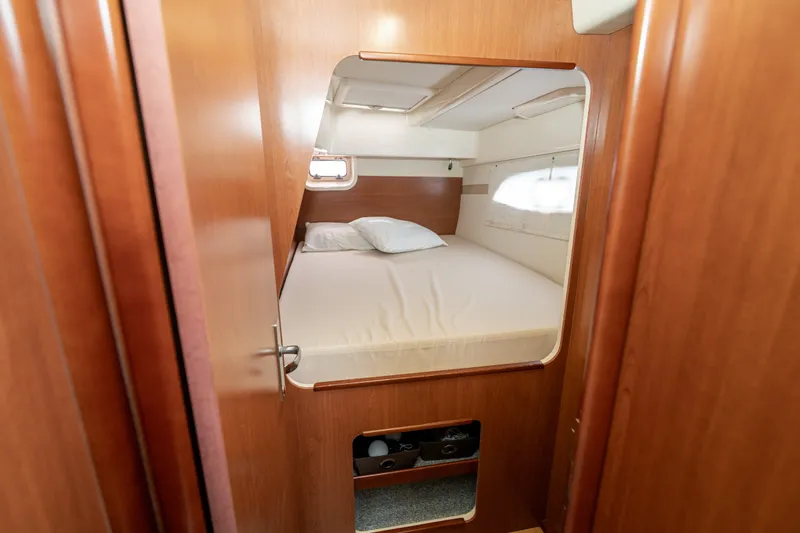 Slide: The Image of Cozy cabin interior of 2011 Leopard 38 yacht with wooden finish and comfortable bedding. - 83