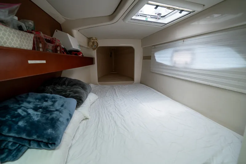 Slide: The Image of Cozy cabin interior of a 2011 Leopard 38 catamaran with bedding and storage. - 116