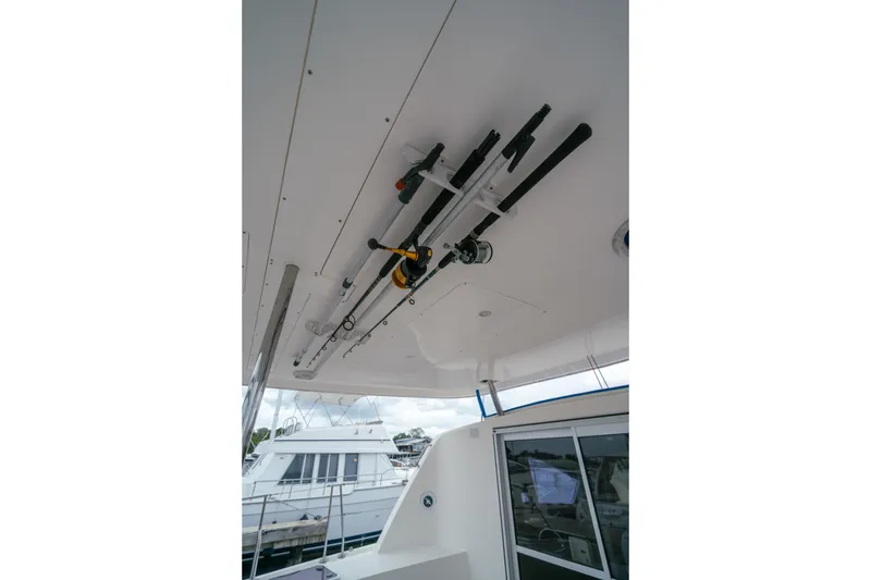 Slide: The Image of Fishing rods stored on a 2011 Leopard 38 boat's ceiling rack at a marina. - 63