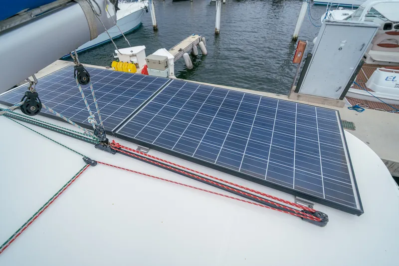 Slide: The Image of Solar panels on a 2011 Leopard 38 catamaran docked at a marina. - 45