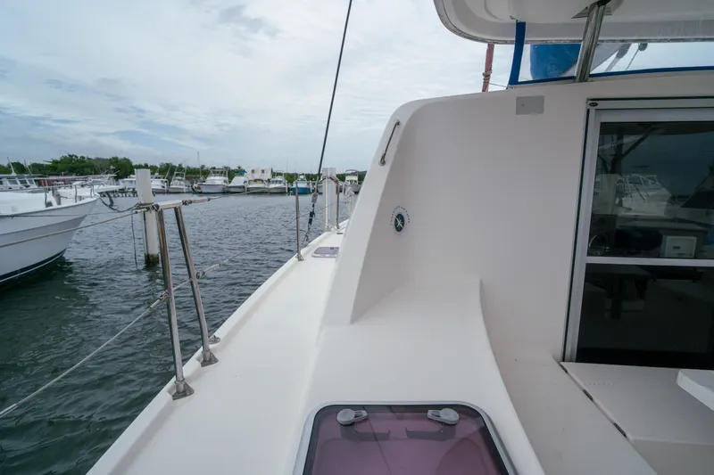 Slide: The Image of 2011 Leopard 38 yacht docked at marina, showcasing sleek deck design and calm waters. - 82