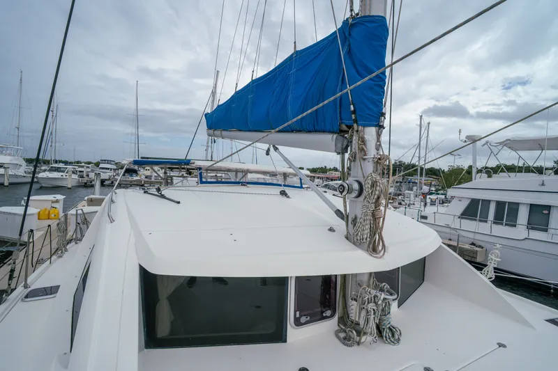 Slide: The Image of Sailing catamaran Leopard 38, 2011 model, docked at marina with blue sail cover. - 41