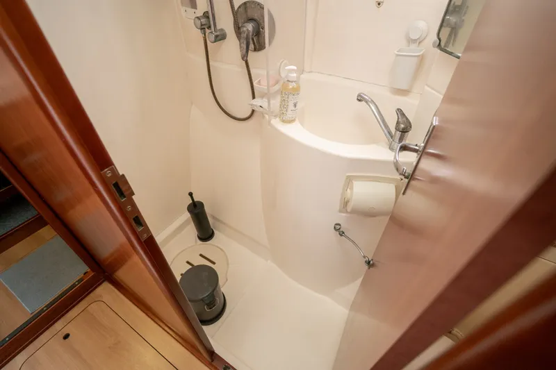 Slide: The Image of Compact bathroom in a 2011 Leopard 38 yacht, featuring a shower and sink. - 89