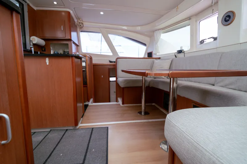 Slide: The Image of Interior of 2011 Leopard 38 catamaran with wood finish and spacious seating area. - 108