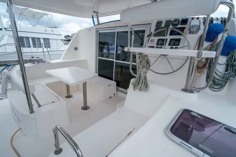Slide: The Image of Cockpit of 2011 Leopard 38 catamaran with steering wheel, seating, and navigation controls. - 61