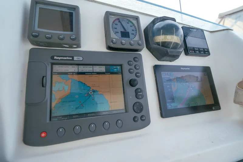 Slide: The Image of Navigation instruments on a 2011 Leopard 38 yacht, featuring Raymarine displays and compass. - 24