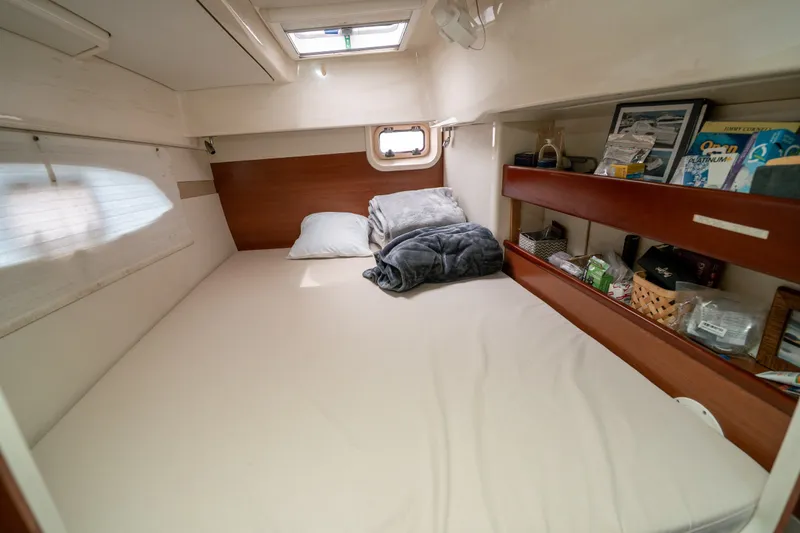 Slide: The Image of Cozy cabin interior of 2011 Leopard 38 yacht with bed and storage shelves. - 124