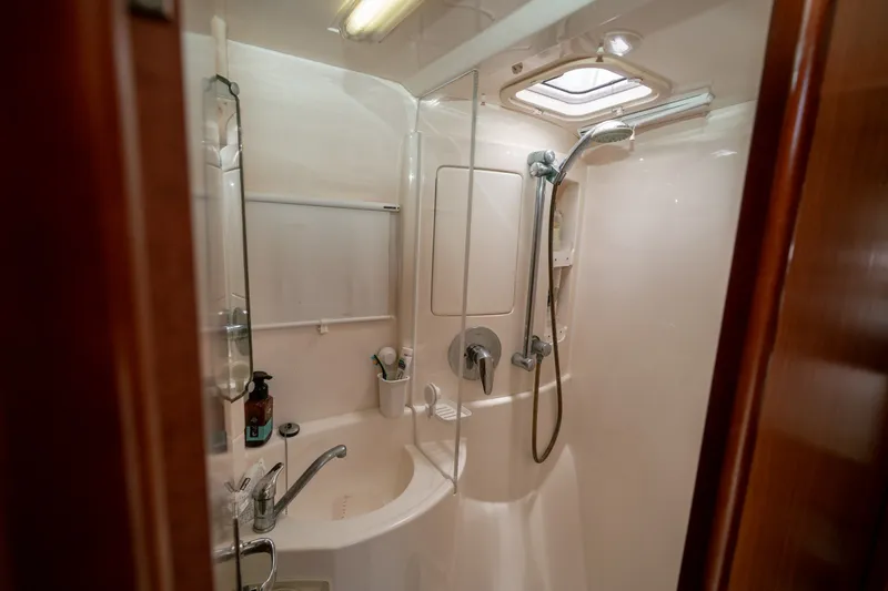 Slide: The Image of Compact bathroom in a 2011 Leopard 38 yacht, featuring a shower and sink. - 121