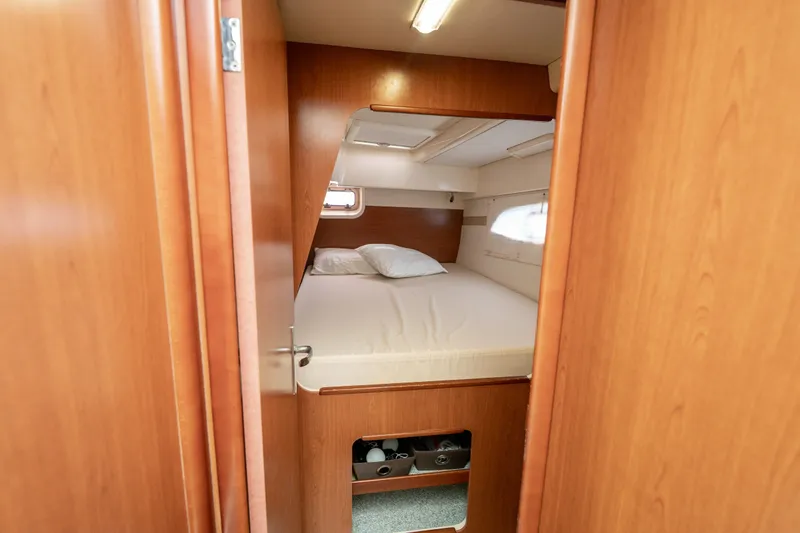 Slide: The Image of Cozy cabin interior of 2011 Leopard 38 yacht with wooden finish and comfortable bedding. - 85