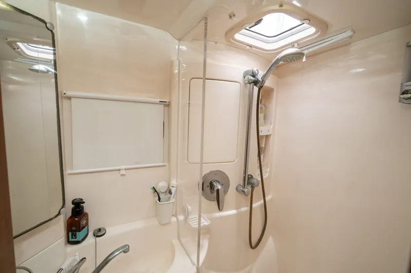 Slide: The Image of Compact bathroom in a 2011 Leopard 38 yacht with shower and skylight. - 118