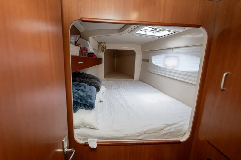Slide: The Image of Cozy cabin interior of a 2011 Leopard 38 catamaran with a comfortable bed and wooden finish. - 115