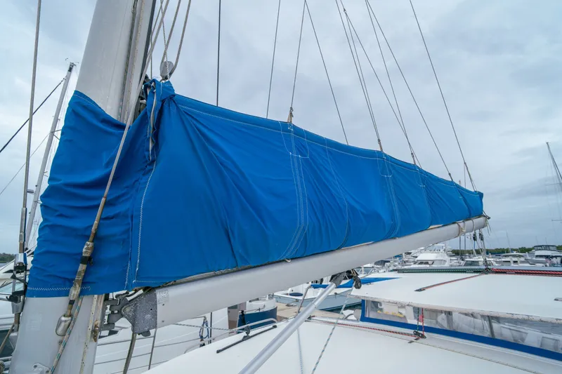 Slide: The Image of Blue sail cover on a 2011 Leopard 38 catamaran, docked in a marina. - 43