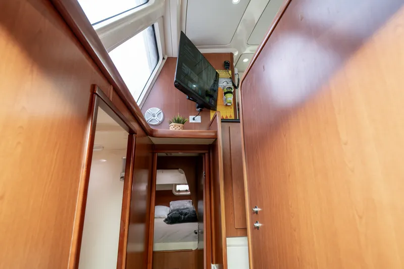 Slide: The Image of Interior of 2011 Leopard 38 yacht with wood paneling and mounted TV. - 127