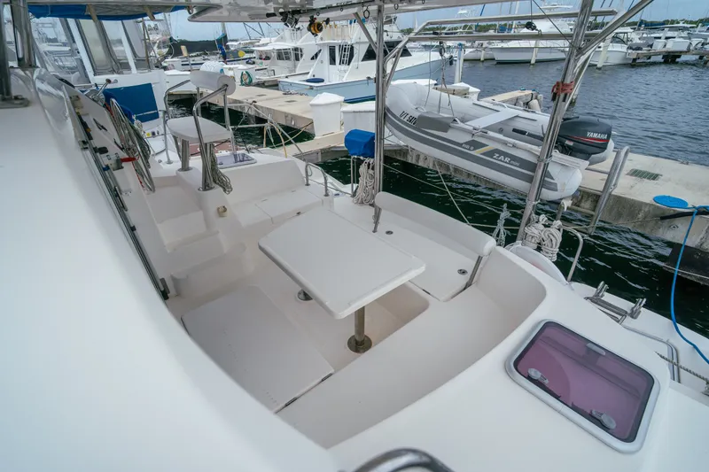Slide: The Image of Spacious deck of 2011 Leopard 38 catamaran docked at marina, featuring seating and table. - 31