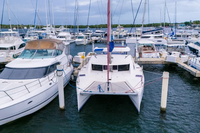 Slide: The Image of Catamaran Leopard 38, 2011 model, docked at a marina surrounded by other boats. - 3