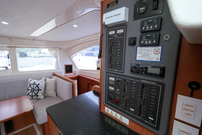 Slide: The Image of Interior of 2011 Leopard 38 yacht featuring control panel and cozy seating area. - 142