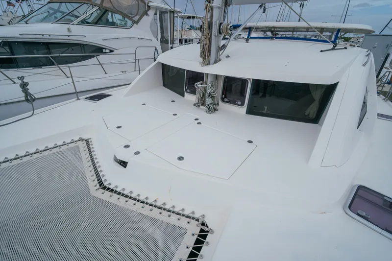 Slide: The Image of 2011 Leopard 38 catamaran deck with netting and sleek design in marina setting. - 36