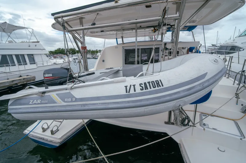 Slide: The Image of Inflatable dinghy "T/T Satori" on Leopard 38 catamaran, 2011 model, docked at marina. - 14