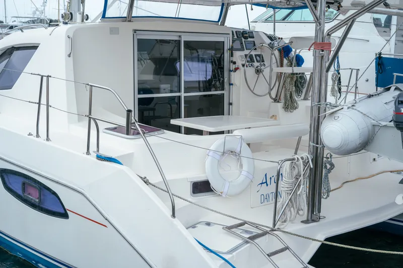 Slide: The Image of 2011 Leopard 38 catamaran with modern deck, ropes, and lifebuoy in marina setting. - 72