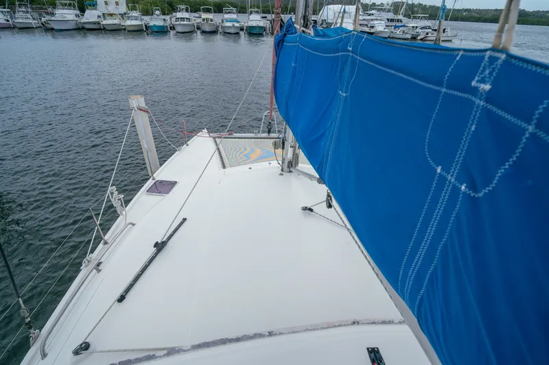 Slide: The Image of Sailing catamaran Leopard 38, 2011 model, docked with blue sail cover, marina background. - 46