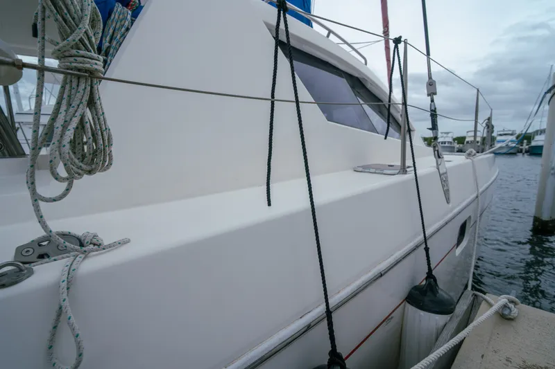 Slide: The Image of 2011 Leopard 38 catamaran docked, showcasing sleek design and nautical ropes. - 51
