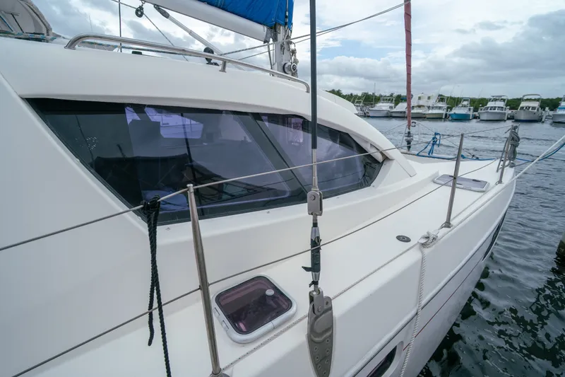 Slide: The Image of 2011 Leopard 38 catamaran docked at marina, showcasing sleek design and spacious deck. - 15