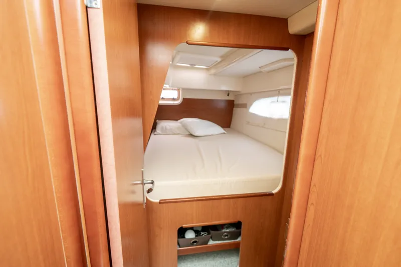Slide: The Image of Cozy cabin interior of 2011 Leopard 38 catamaran with wooden finish and comfortable bedding. - 84