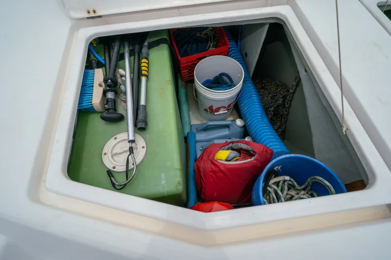 Slide: The Image of Storage compartment on a 2011 Leopard 38 boat with tools and equipment. - 157