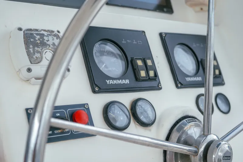 Slide: The Image of Close-up of a 2011 Leopard 38 yacht dashboard with Yanmar gauges and steering wheel. - 68