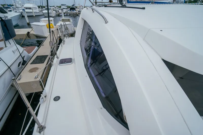 Slide: The Image of 2011 Leopard 38 catamaran docked at marina, showcasing sleek design and spacious deck. - 48