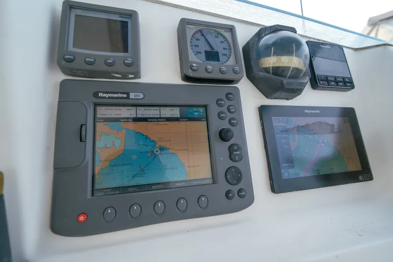 Slide: The Image of Navigation equipment on a 2011 Leopard 38 yacht, featuring Raymarine displays and compass. - 23
