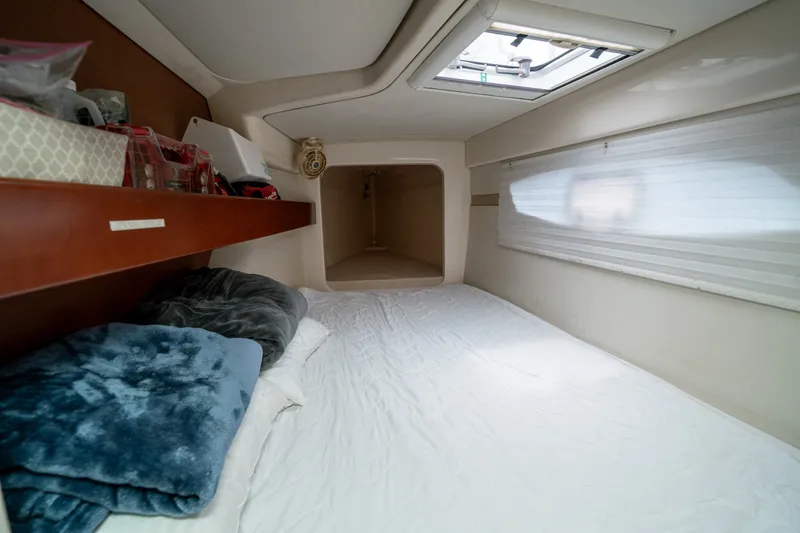 Slide: The Image of Cozy cabin interior of 2011 Leopard 38 yacht with bed, skylight, and storage shelf. - 117