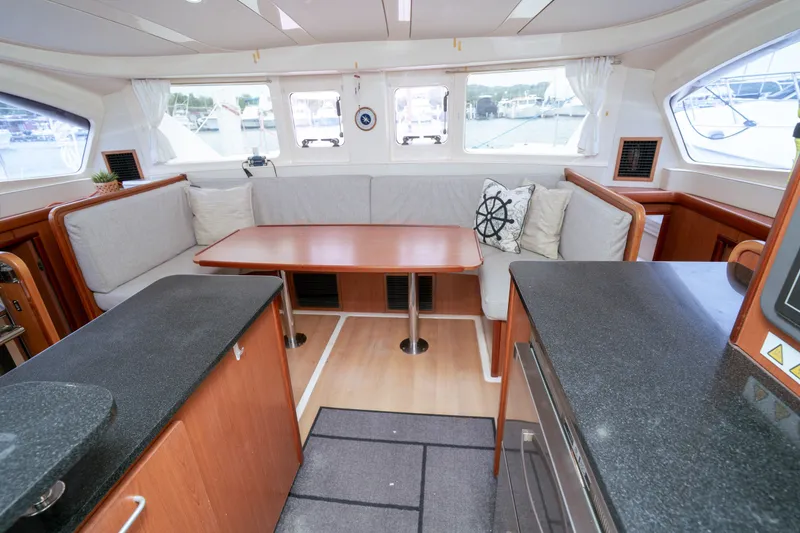 Slide: The Image of Spacious interior of 2011 Leopard 38 catamaran with cozy seating and wooden table. - 141