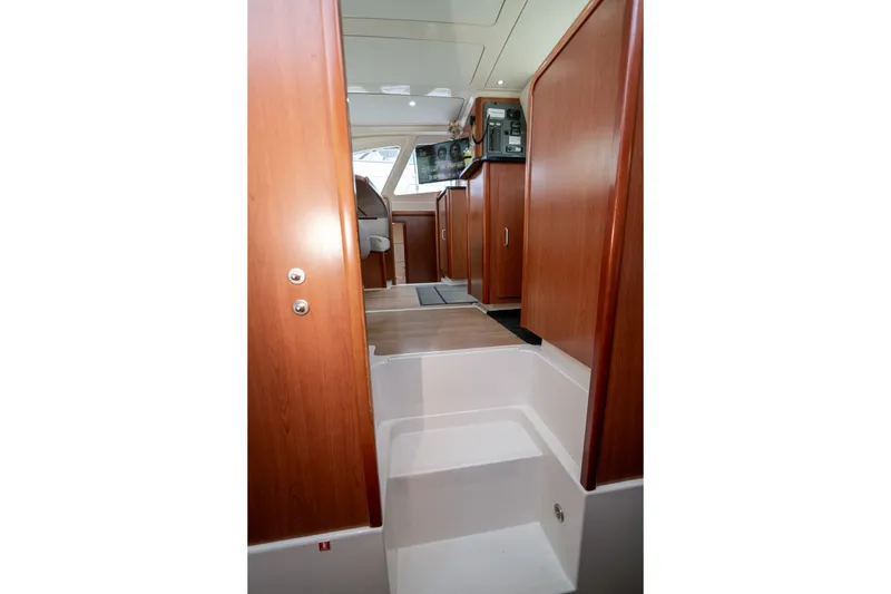 Slide: The Image of Interior view of 2011 Leopard 38 yacht, featuring wooden cabinetry and modern helm station. - 100
