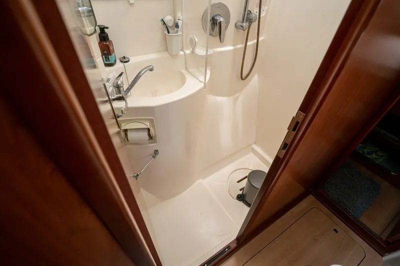 Slide: The Image of Compact bathroom in a 2011 Leopard 38 yacht, featuring a shower and sink. - 120