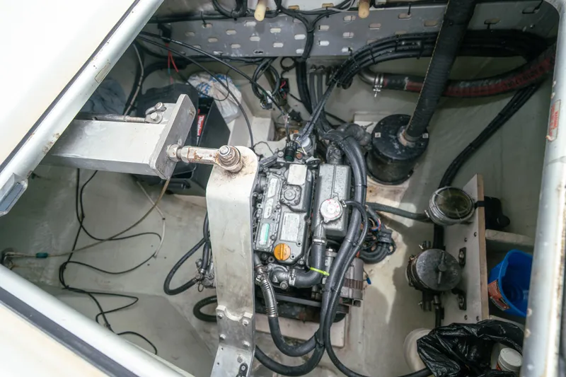 Slide: The Image of Engine compartment of a 2011 Leopard 38 catamaran, showcasing mechanical components and wiring. - 144