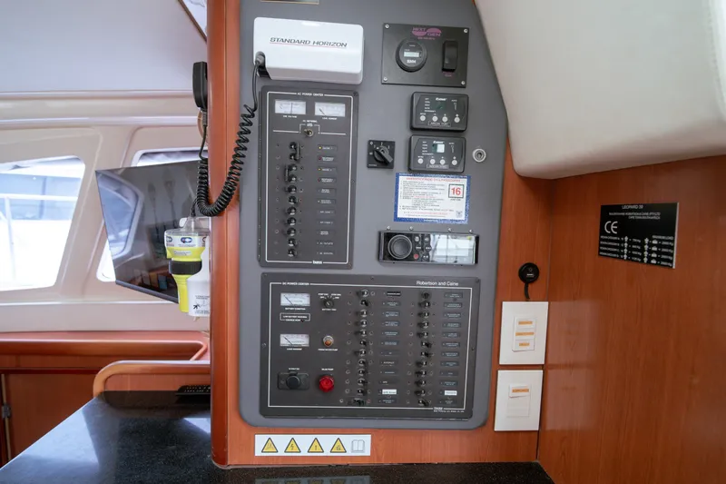 Slide: The Image of Electrical control panel inside a 2011 Leopard 38 catamaran, featuring various switches and gauges. - 136