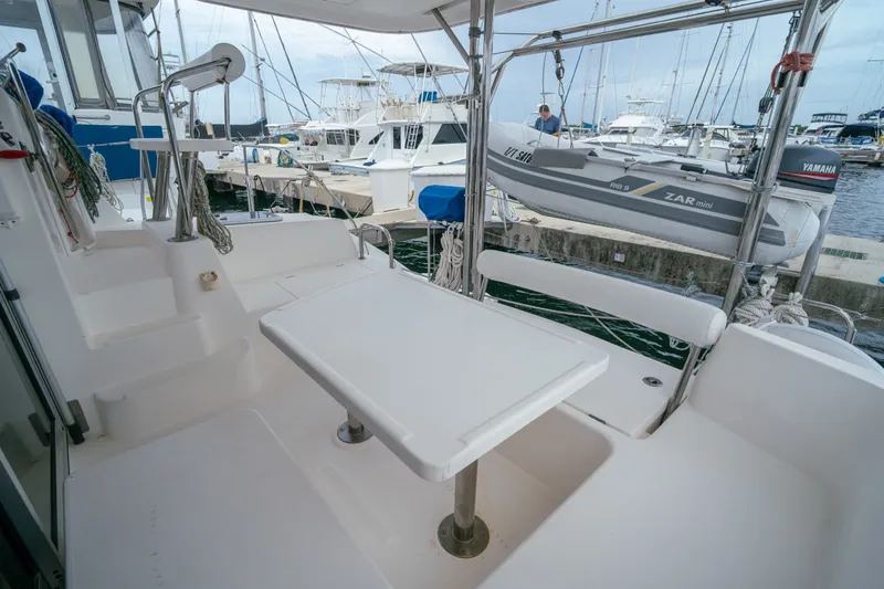 Slide: The Image of Cockpit view of 2011 Leopard 38 catamaran with seating and table, docked at marina. - 59