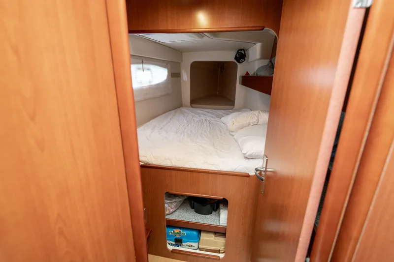 Slide: The Image of Cozy cabin interior of 2011 Leopard 38 yacht with bed and wooden storage. - 93