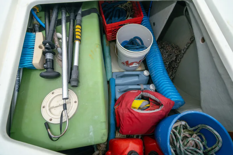 Slide: The Image of Storage compartment on a 2011 Leopard 38 boat, filled with marine equipment and supplies. - 159