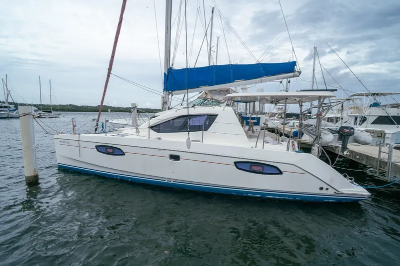 Slide: The Image of 2011 Leopard 38 catamaran docked at marina under cloudy sky. - 13