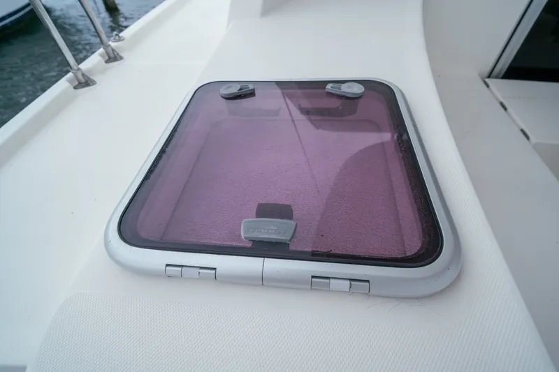 Slide: The Image of Hatch on 2011 Leopard 38 yacht deck, featuring a tinted cover and secure latches. - 56