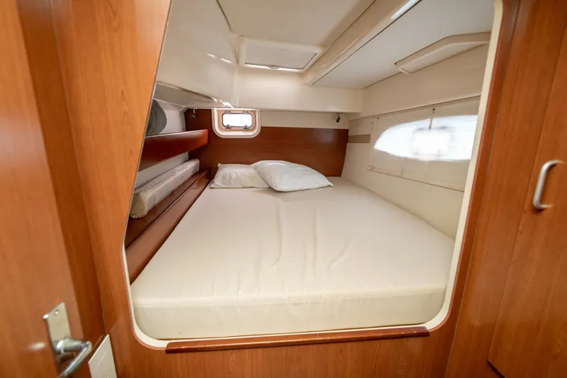 Slide: The Image of Cozy cabin interior of 2011 Leopard 38 yacht with comfortable bed and wooden finish. - 86