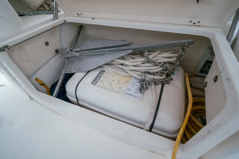 Slide: The Image of Storage compartment on a 2011 Leopard 38 boat with anchor, rope, and rescue equipment. - 161