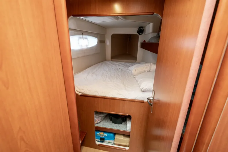 Slide: The Image of Cozy cabin interior of 2011 Leopard 38 yacht with bed and wooden finish. - 94